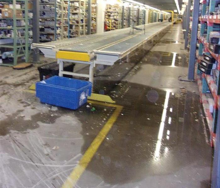 Pool of water on warehouse floor.