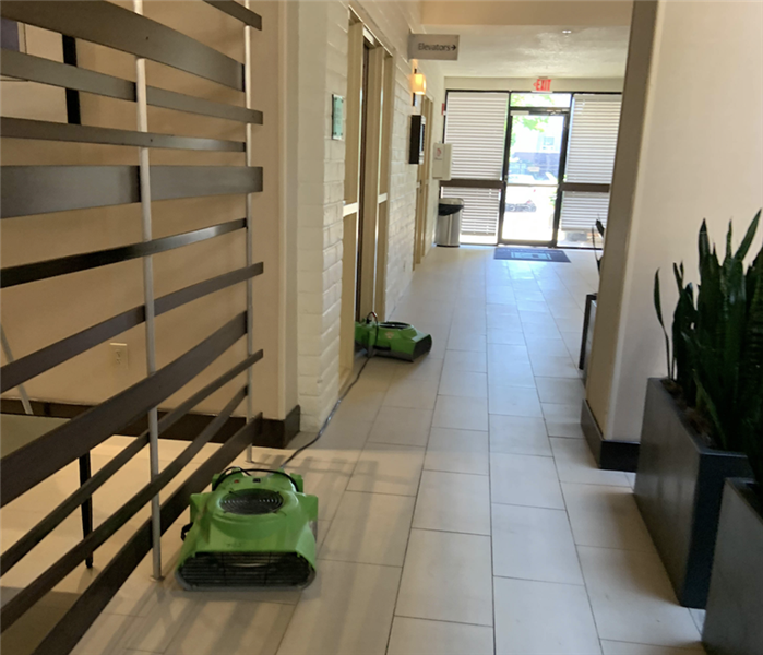 Air movers in commercial hallway.