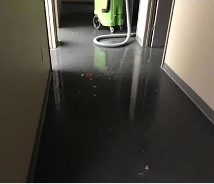 tile floor in hallway with water standing