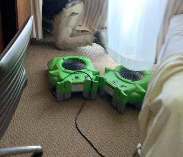 Air movers in action in a bed room.